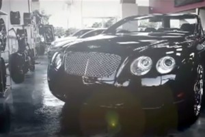 A black bentley parked in the rain.